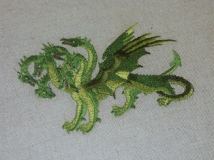 Detail of embroidered dragon on upholstery. Detail of embroidered dragon on upholstery.