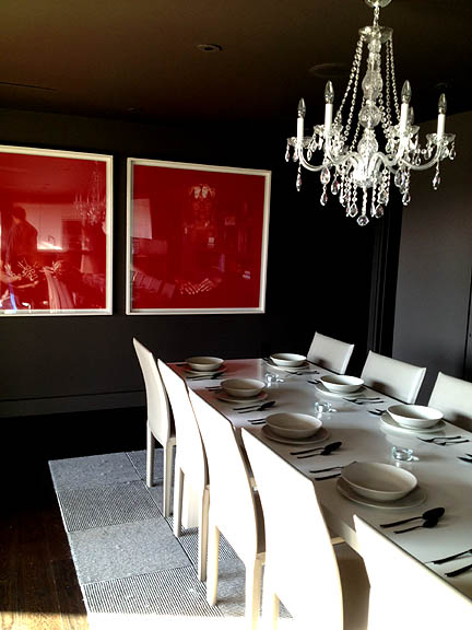 This dramatic, chocolate dining room is the perfect foil for the pop of red in the artwork.