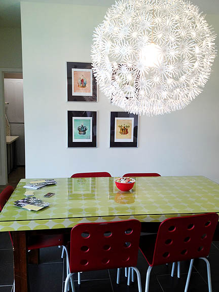 Here's a budget-friendly way to update an old dining table. Wrap the top in oil cloth and add a glass top!