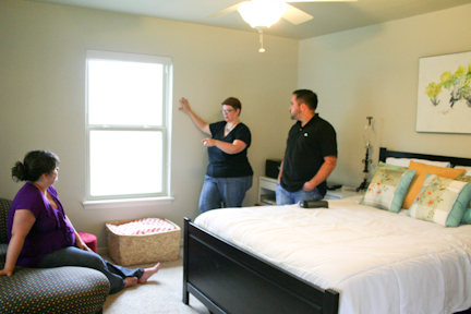 Room Fu Design Guru Robin Callan (center) makes suggestions for window treatments in Tara and Justin's guest bedroom.