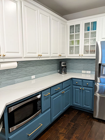 White and blue kitchen remodel in Austin TX featuring under-cabinet microwave and mid-century modern tile backsplash.