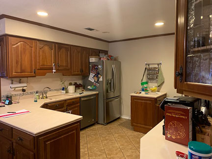 Austin kitchen before remodeling, featuring outdated country cabinets and an odd layout.