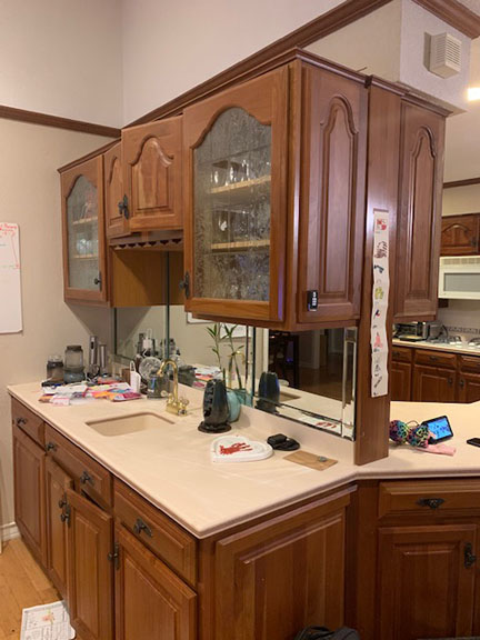 Austin wet bar before kitchen remodel, featuring outdated country cabinets.