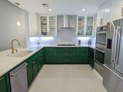 Austin kitchen after remodel, with emerald green and white Shaker style cabinetry.