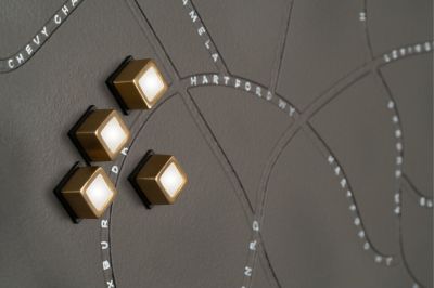 Matt Locke's multimedia piece, "The Film Colony," featuring a debossed leather map and brass LED lights.